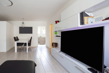 Living room with leather sofa and white walls