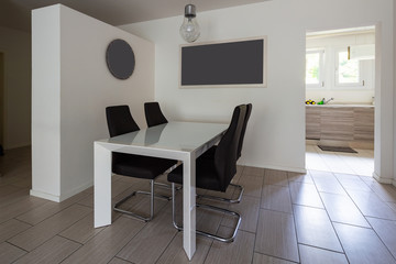 Dining room with leather chairs and open door to the kitchen