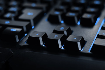 gamer keyboard with blue back-light for hacker cyber attacks