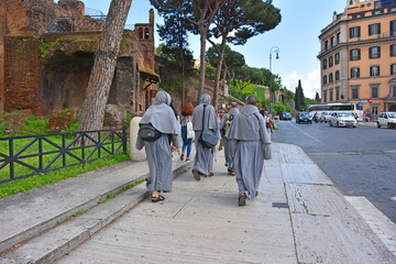 Rome, monks walk along a city street.