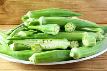 fresh okra vegetable in wooden table background