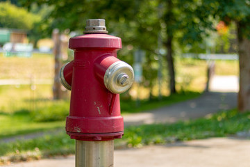 Fototapeta na wymiar TODTMOOS, GERMANY - JULY 20 2018: Red Fire Hydrant in Park Todtmoos