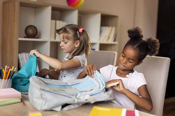 Girls packing school bags