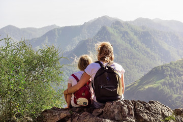 Woman and child looking into the distance to the mountains