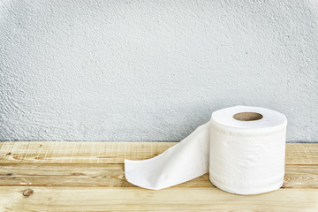 roll of tissue paper on wooden floor background
