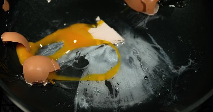 Egg bursting into a stove, slow motion 4K