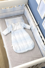 Fototapeta na wymiar Interior of light cozy baby room with crib and bedding