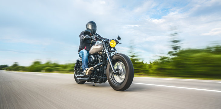Fototapeta motorbike on the road riding. having fun riding the empty road on a motorcycle tour / journey