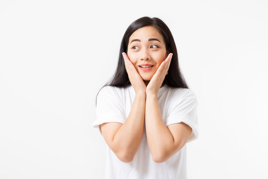 Surprised shocked excited asian woman face isolated on white background. Young asian girl in summer t shirt. Copy space