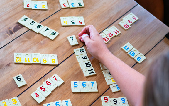 Hand on table playing rummy game
