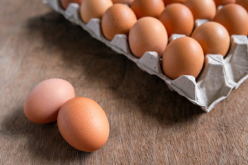 Fresh chicken eggs eggs in paper tray,egg carton on wooden background.