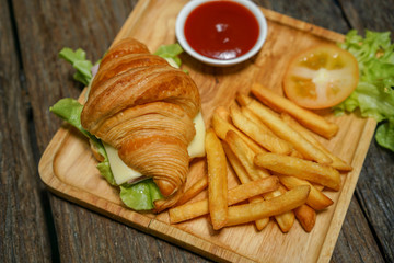 Croissant ham cheese delicious breakfast on wooden table