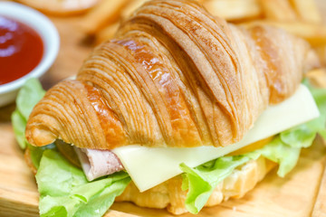 Croissant ham cheese delicious breakfast on wooden table