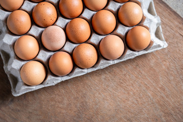 Fresh chicken eggs eggs in paper tray,egg carton on wooden background.