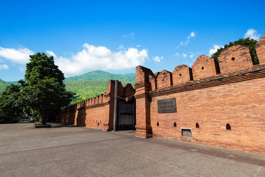 Tha Phae Gate Chiang Mai old city ancient wall and moat on Forested Mountain blue sky background with white clouds It is a major tourist attraction in Chiang Mai, Thailand.