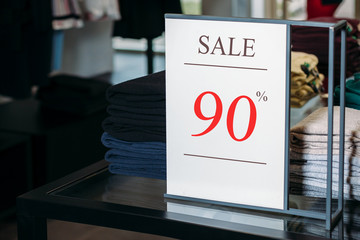 Sign in a clothing store with discount inscription SALE 90 % percent. Plate discount (sale)