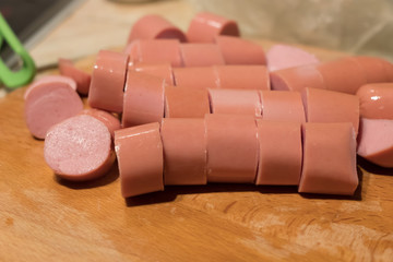 Sliced sausage rings on the wooden table