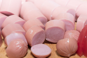 Sliced sausage rings on the wooden table