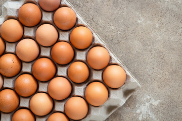 Fresh chicken eggs eggs in paper tray,egg carton on wooden background.