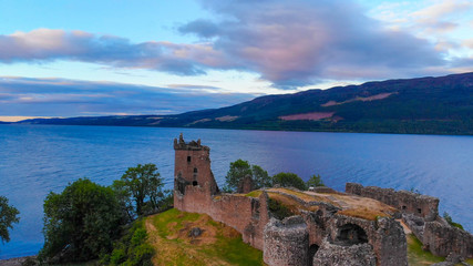 Fototapeta premium Urquhart Castle and Loch Ness in the evening - aerial drone view