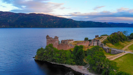 Fototapeta premium Urquhart Castle and Loch Ness in the evening - aerial drone view