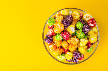 Sweet colored popcorn on bright background