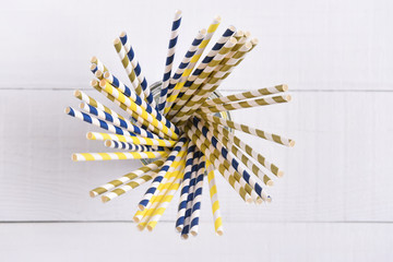 Top view of a glass filled with multi colored eco-friendly paper drinking straws