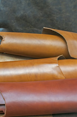 Closeup of various colors natural cow leather fabric rolls