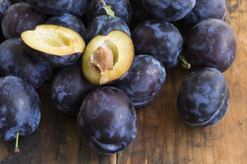 Ripe Plums on a Wooden Background