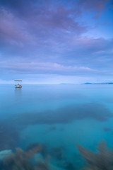 Boat in adriatic sea at sunrise near Split,long exposure