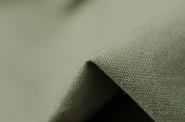 Green military cloth macro fittings clothing on blur background