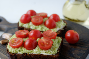 Bread with cottage cheese, avocado and cherry tomatoes