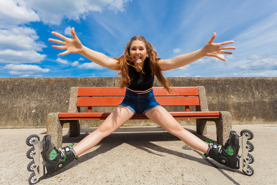 Joyful girl wearing roller skates