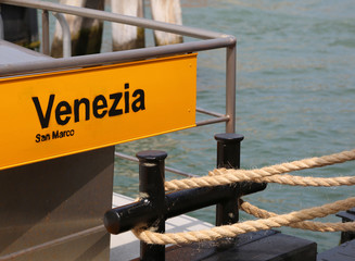 big banner with text Venezia San Marco in the water bus station