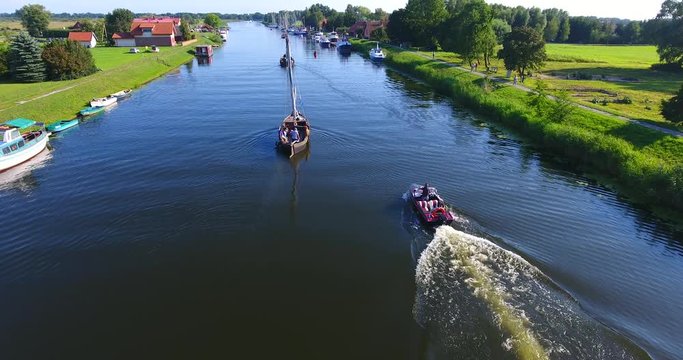 Minge village near the river. Drone camera flaying over the marina on a countryside on a sunny summer day - 005