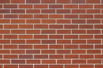 Reddish brown brick wall background in traditional running bond pattern
