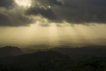 Beautiful and dramatic sunset with sun beams hitting a mountainn range in Panama - obrazy, fototapety, plakaty