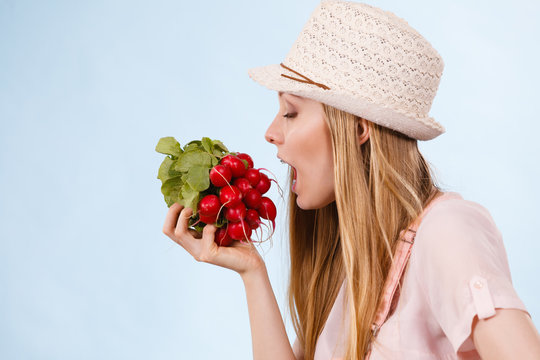 Happy woman holding radish