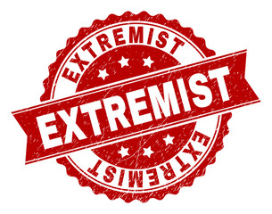 EXTREMIST seal stamp with distress texture. Rubber seal imitation has round medallion form and contains ribbon. Red vector rubber print of EXTREMIST label with grunge texture.