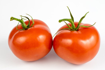Red tomatoes on a white table. Tasty vegetables for the best dishes in the kitchen.