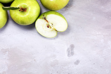 Ripe red apples with leaves on wooden background.
