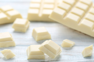 White chocolate pieces on wooden table