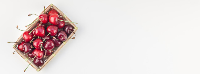 Fresh ripe cherry in a small wicker basket