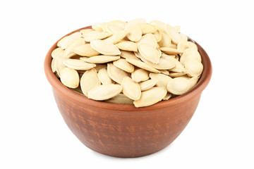 Pumpkin seeds in bowl isolated on a white background