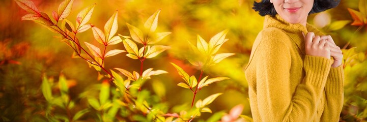Composite image of woman in winter clothing posing against white