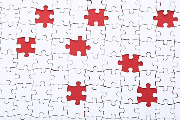 White jigsaw puzzle on red background