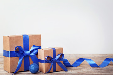 Brown gift boxes with bauble on grey wooden table
