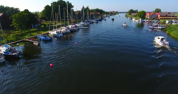 Minge village near the river. Drone camera flaying over the marina on a countryside on a sunny summer day - 006