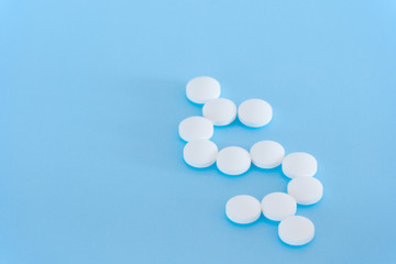 White pills on a blue background
