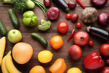 Ripe fruits and vegetables on brown wooden table